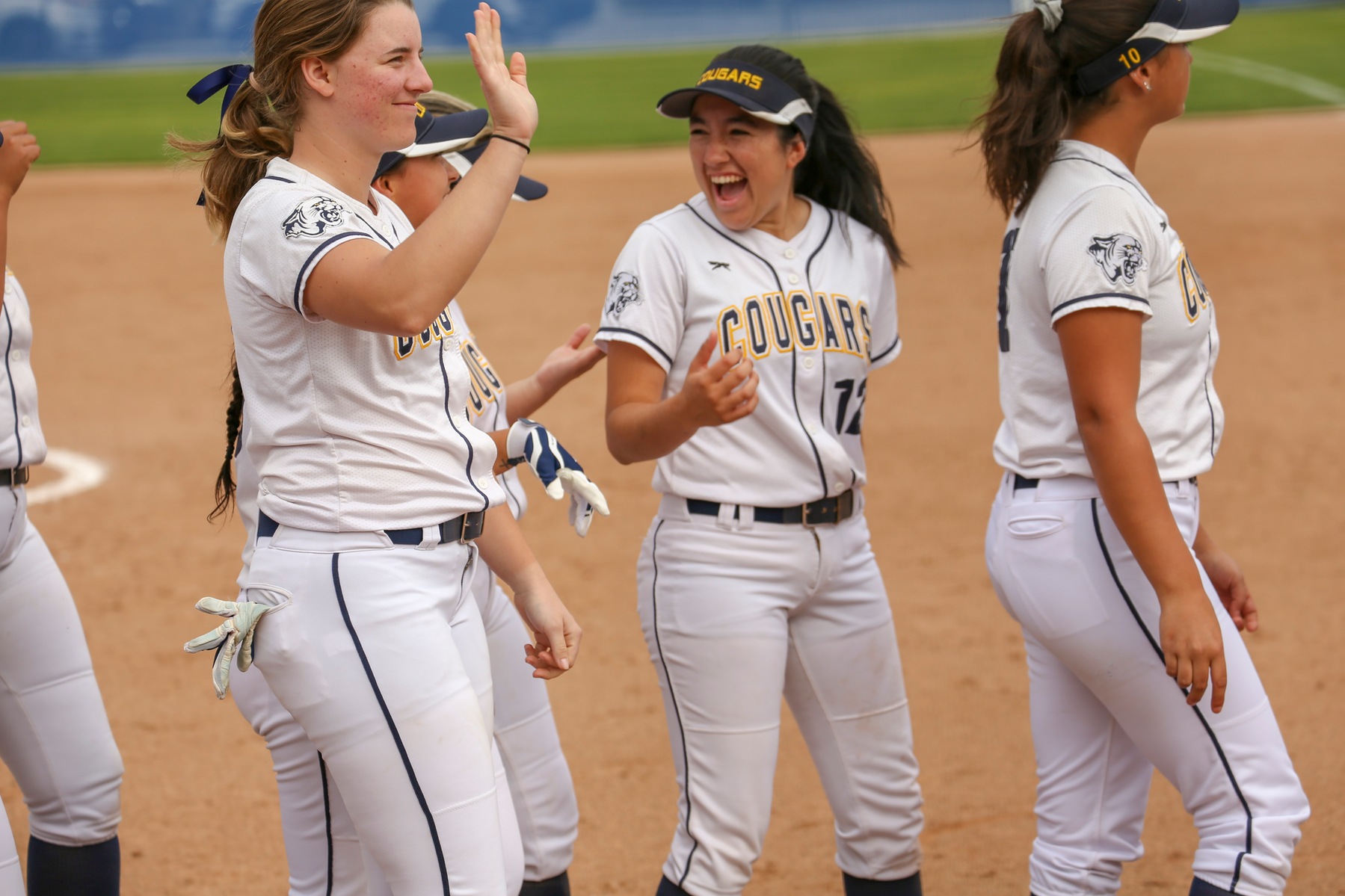 College of the Canyons softball players celebrate after a game.