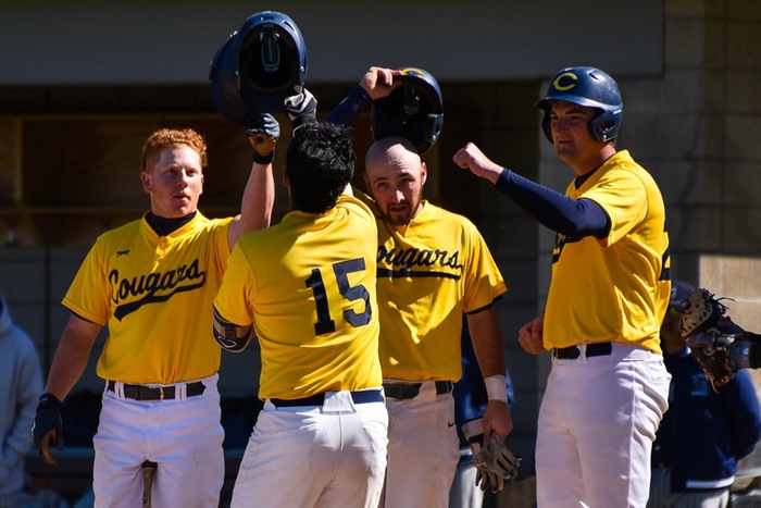 Stock image of College of the Canyons baseball players Jake Schwartz, Charlie Rocca and Andrew Allanson meeting Andy AMbrix at home plate for a home run celebration.