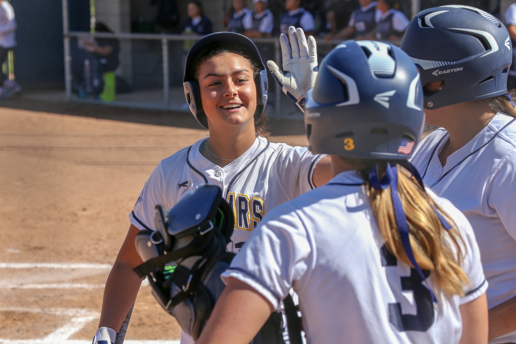 COC softball player Camryn Webb high fives a teammates during game on March 12, 2019.
