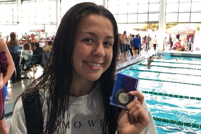 College of the Canyons freshman swimmer Alyssa Hamilton holding a swim medal during Day three of the CCCAA Swim &amp; Dive Championships at East L.A. College.