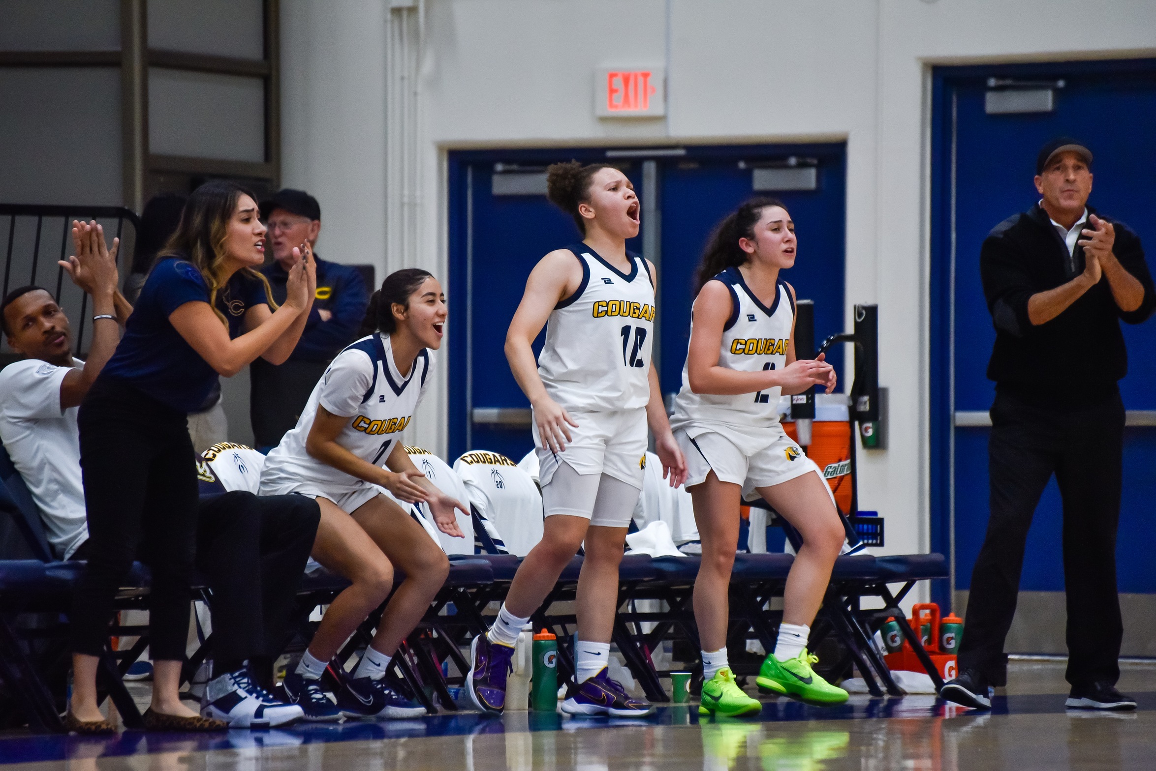 College of the Canyons women's basketball stock action photo showing players and coaches in celebration from game on Dec. 30, 2023.