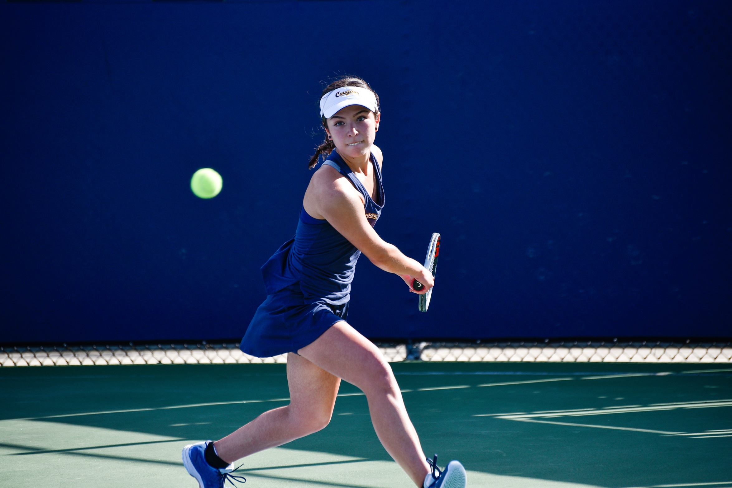 Stock action image of College of the Canyons women's tennis player Estrella Segura.