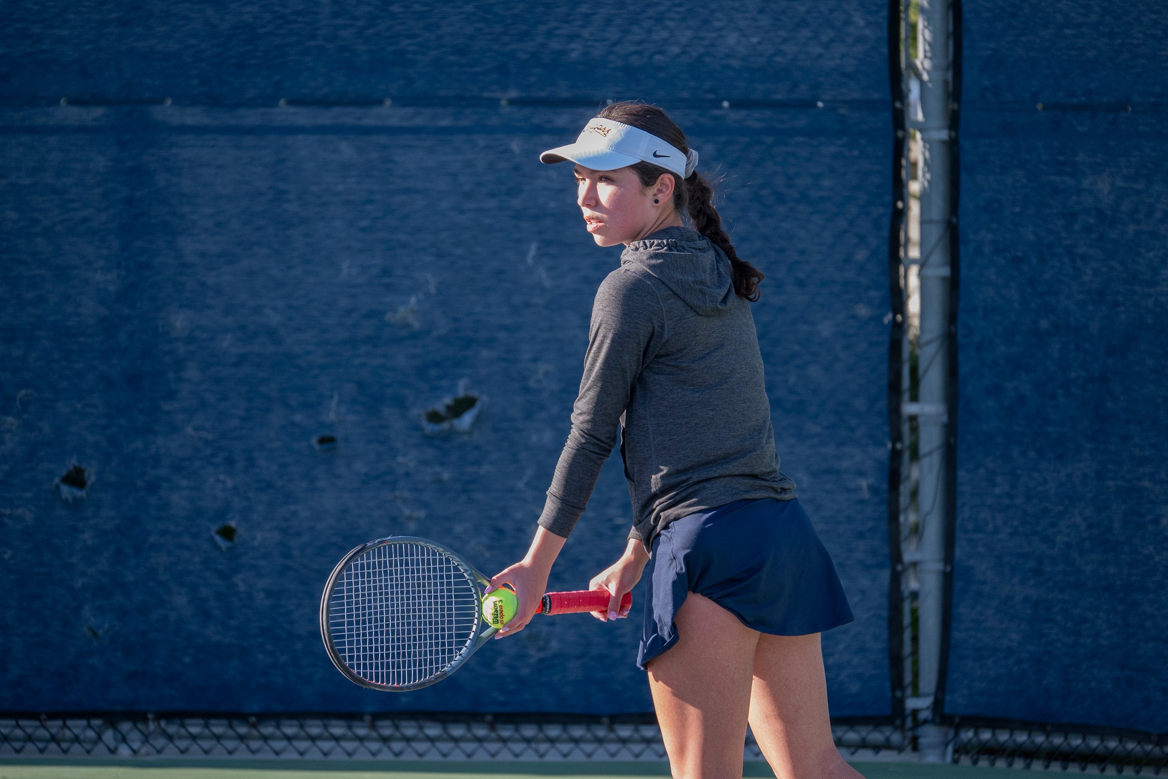 Stock action image of College of the Canyons women's tennis player Estrella Segura during match vs. Antelope Valley College on Feb. 13, 2024.