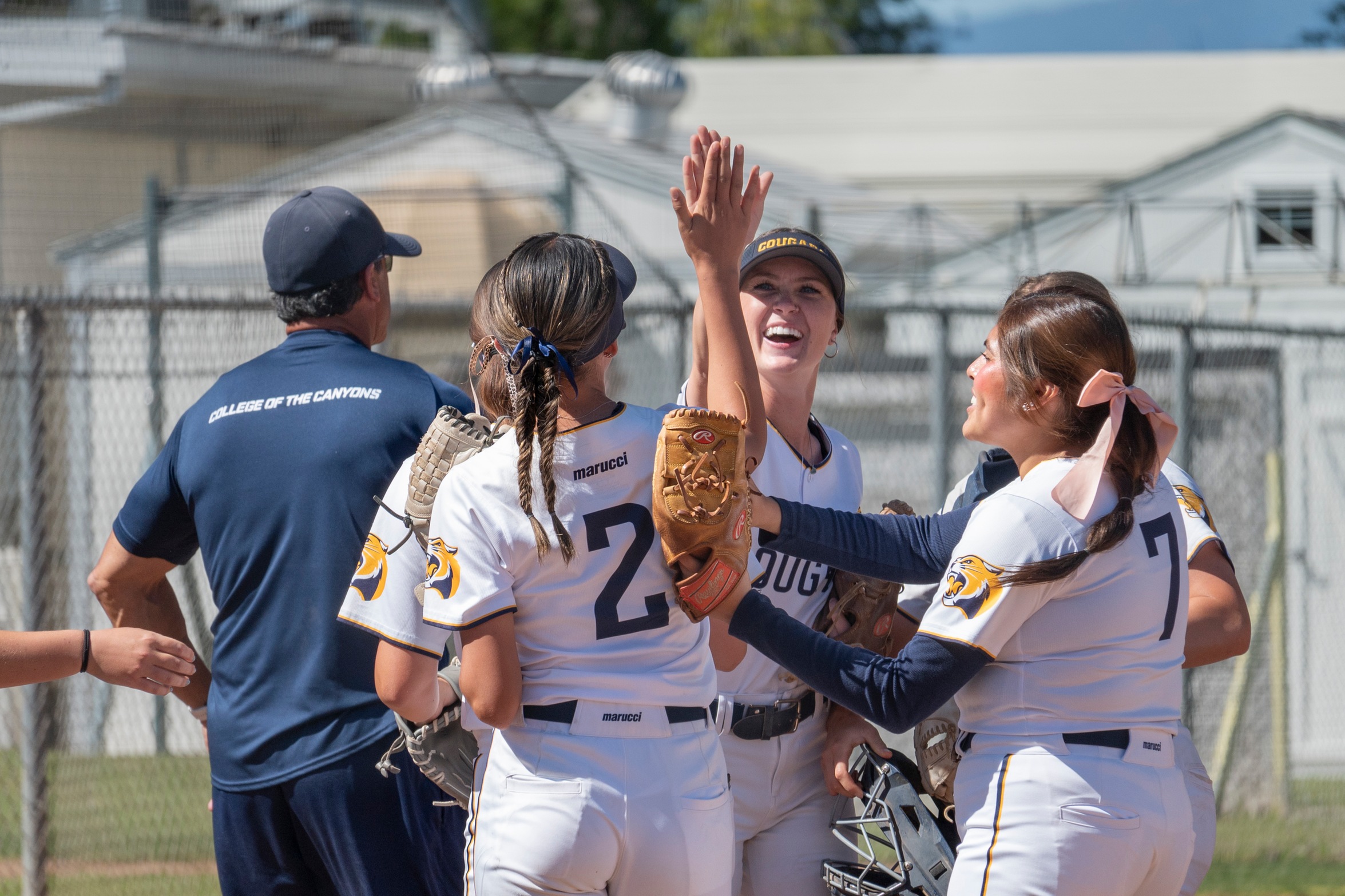 College of the Canyons softball players giving high fives after a recent victory.